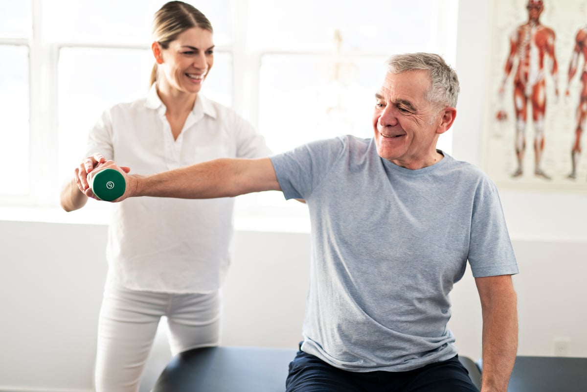 A Modern rehabilitation physiotherapy worker with senior client